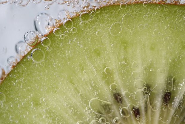A close-up of a slice of kiwi fruit.