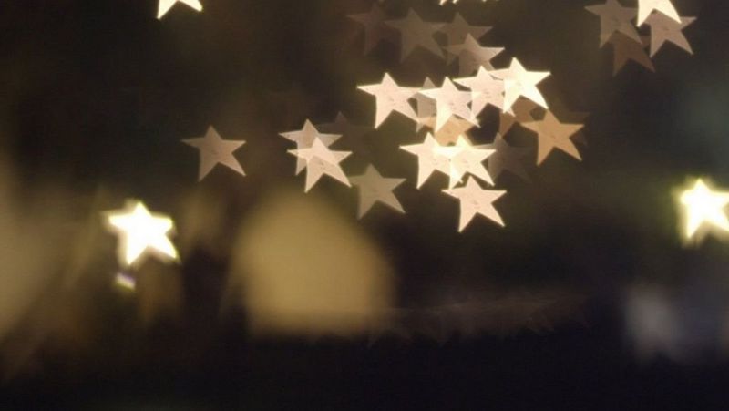 A blurred image with out-of-focus highlights in the shape of five-pointed stars rather than circles.