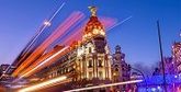 Light trails suspended in motion by a bus on a busy street in Madrid, Spain.
