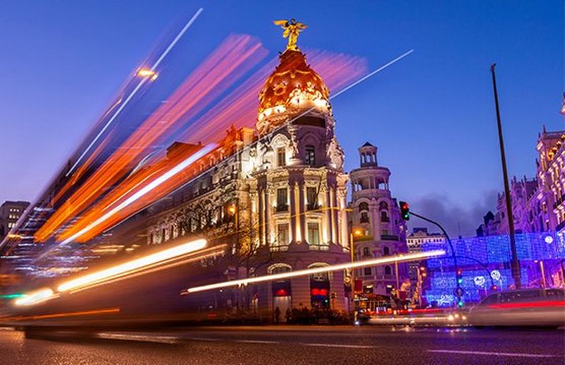 Light trails suspended in motion by a bus on a busy street in Madrid, Spain.