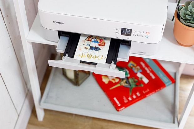  A personalised card on the paper tray of a Canon printer.