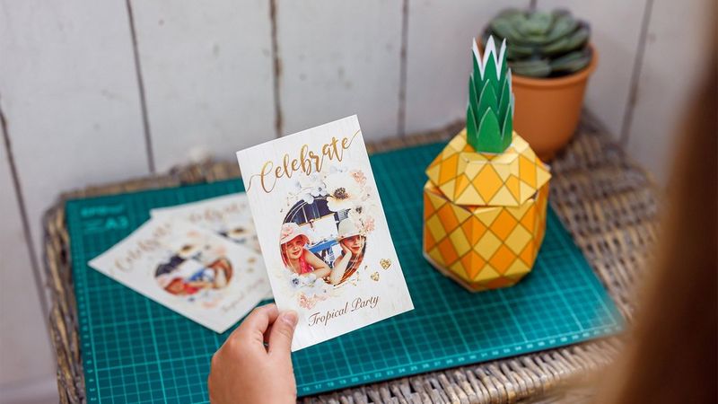 A girl holds a personalised card created with the Creative Park app. 