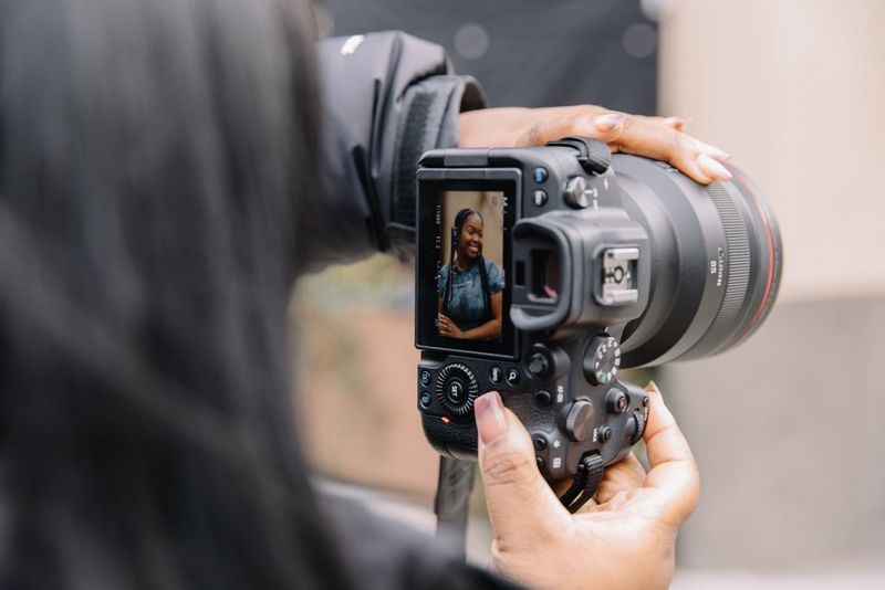 The back of a Canon EOS R6 showing a portrait of a woman on the touchscreen.