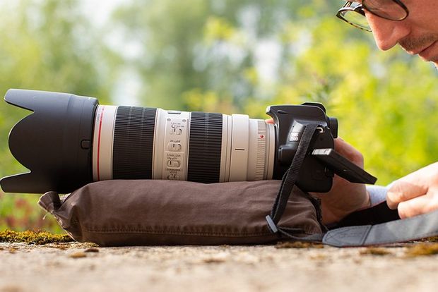 A Canon EOS 250D with a Canon EF 70-200mm f/2.8L IS III USM lens rests on a homemade beanbag.