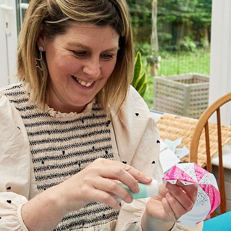 Crafter Emma Howcutt-Kelly smiles as she glues together a papercraft ice cream from Canon Creative Park.