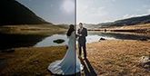A before and after shot of a couple on their wedding day next to a lake, dark and unedited on the left, showing the lighter version on the left, edited in DPP.