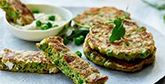 Pea fritters on a plate, shot from the side.