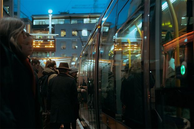Crowds waiting to board a tram in Dublin.