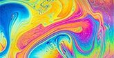 Swirling multicoloured patterns of soap in water. 