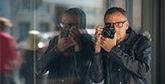 Piotr Malecki taking photos on the street.