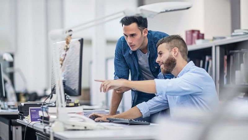 Two work professionals working together in the office