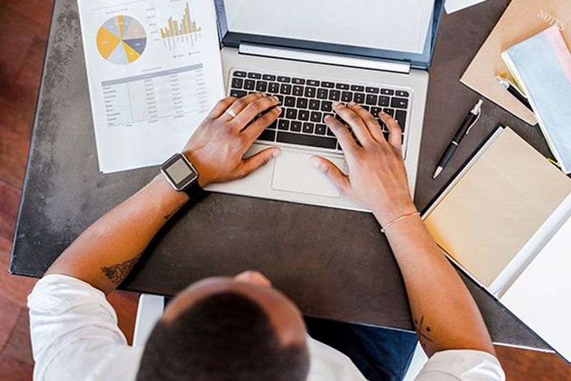 an image of man on laptop invoice data