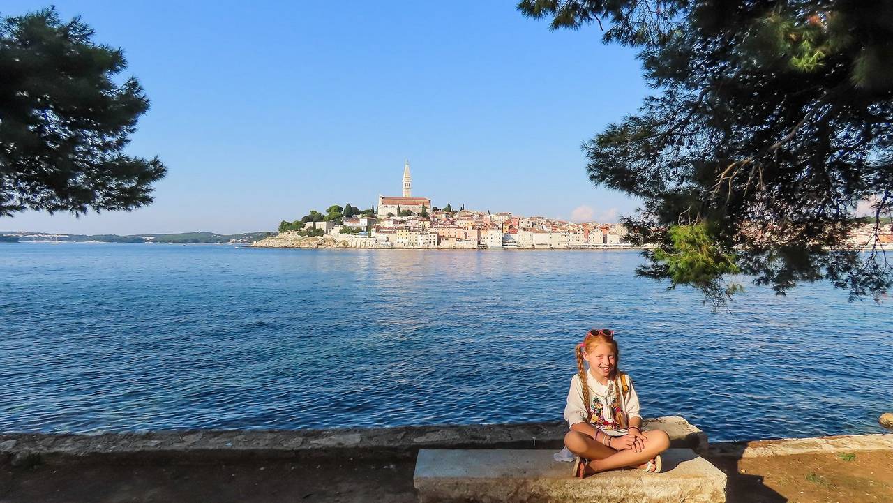 girl-sitting-on-bench-with-view-behind-her