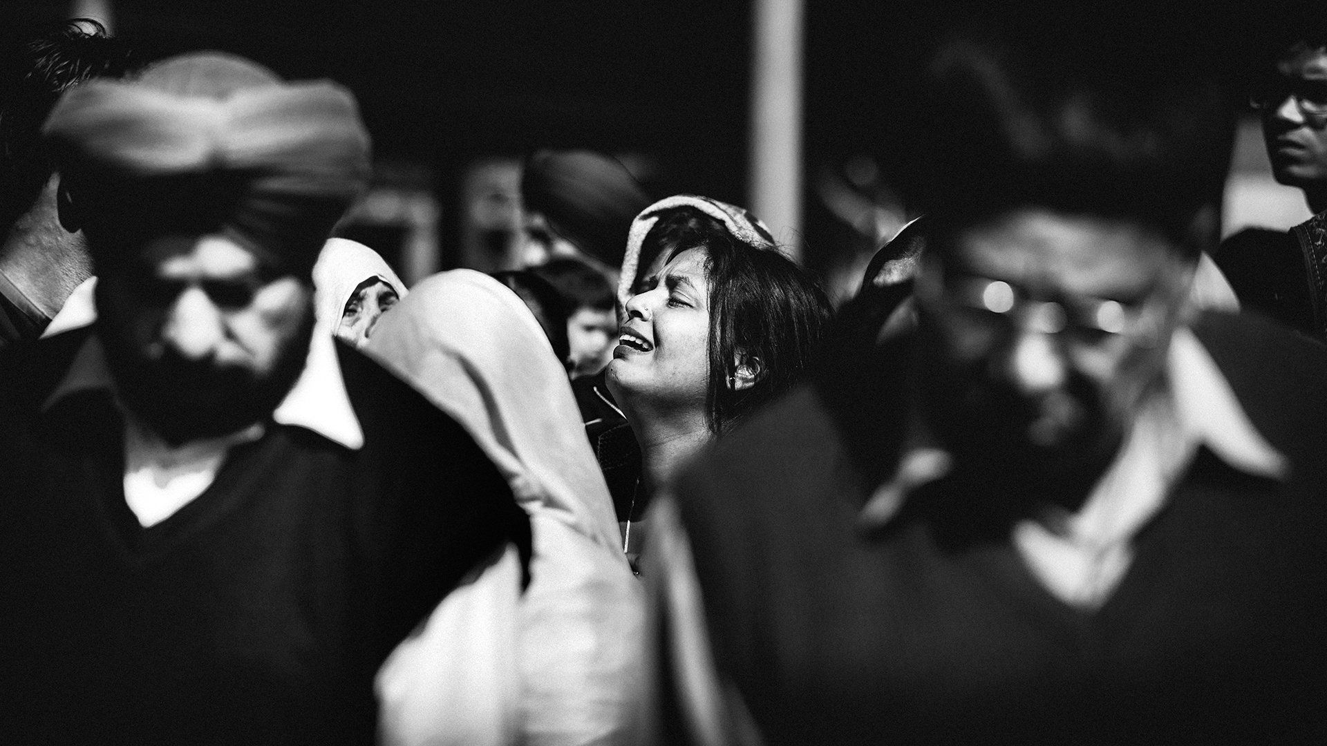 Woman crying in a crowd