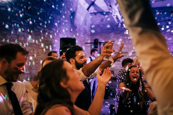 Wedding guests dancing at an evening party.