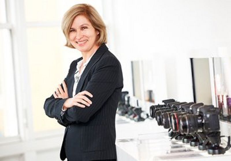 Caroline Serfass, Senior VP and CIO, Canon Europe, smiling with her arms folded.