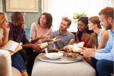 Group of friends taking part in book club