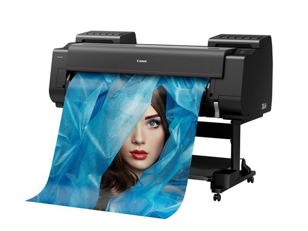 A Canon imagePROGRAF PRO-4000 printer outputting a poster-size image of a woman's face shrouded in blue.