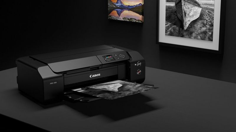 A Canon imagePROGRAF PRO-300 prints out a striking black-and-white image of a boat.