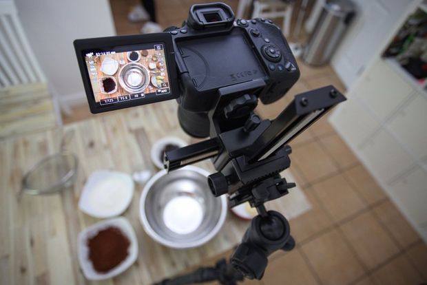 A Canon EOS 90D on a tripod filming ingredients laid out on a table.