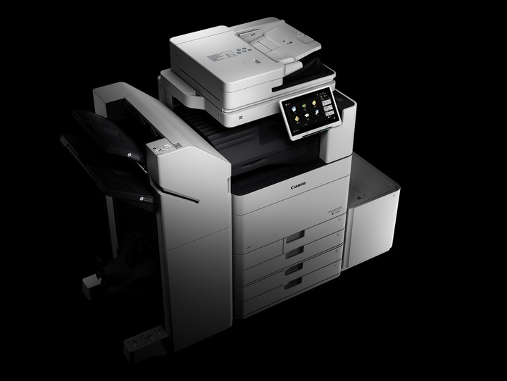Canon office multi-function printer with touchscreen and a black background.