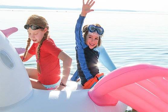 kids playing on water floats on holidays