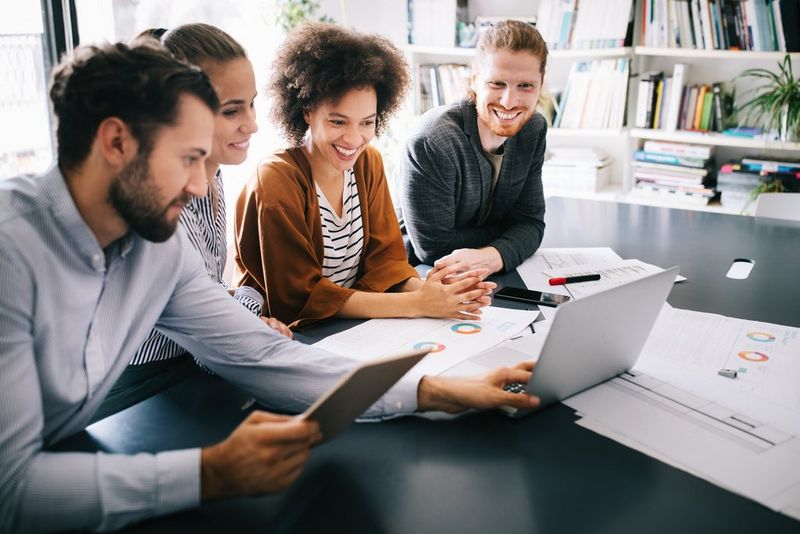 Work professionals discussing Fujitsu Managed Print Service Case Study