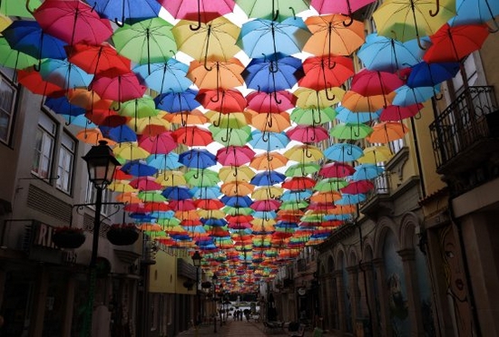 Narrow street canopied by umbrellas RF 35mm F1.8 MACRO IS STM