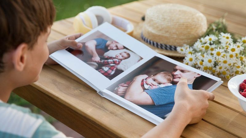 Child looking at printed photo album