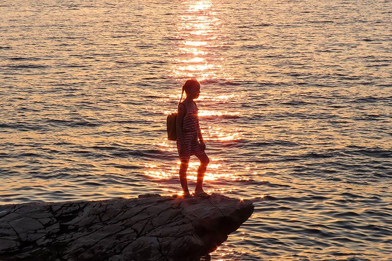 woman standing on rock formation