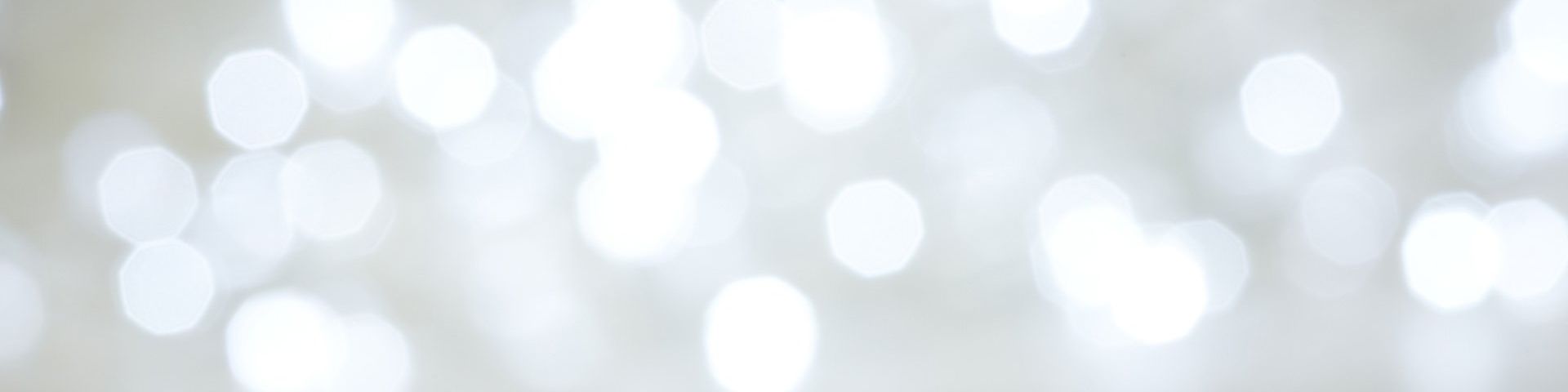 Dozens of lights, slightly blurred to create an abstract background in white and grey.