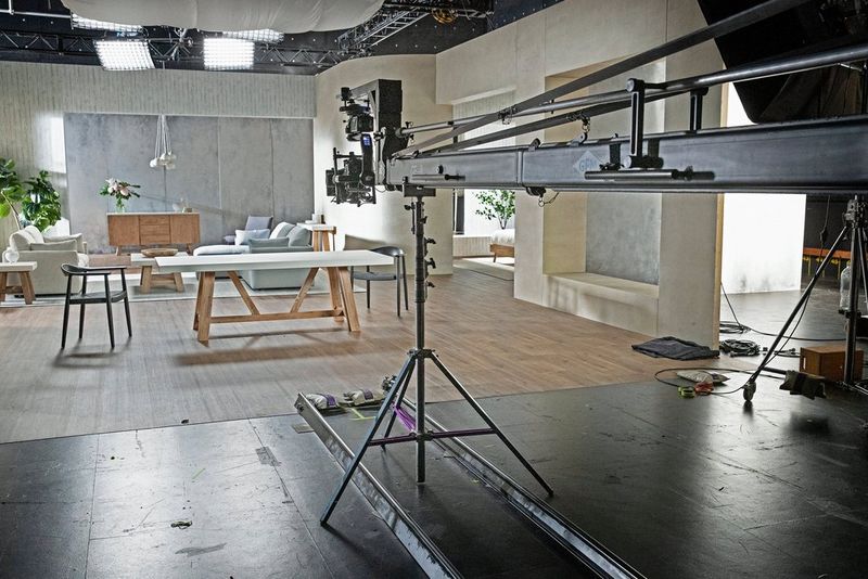 A grey and white furniture set with a Technocrane set up to film over the top.