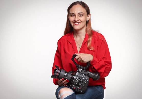 Cinematographer and Canon Video Ambassador Elisa Iannacone holding a Canon Cinema EOS camera.