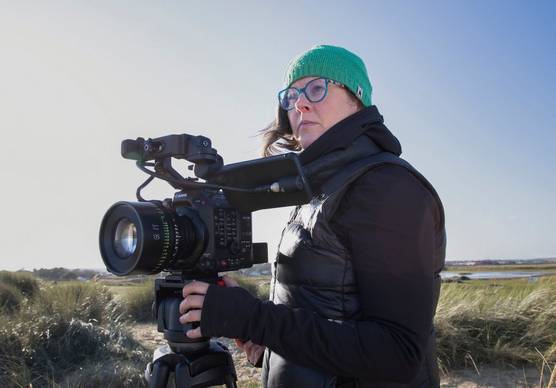 Cinematographer and Canon Video Ambassador Tania Freimuth standing behind a Canon Cinema EOS camera.