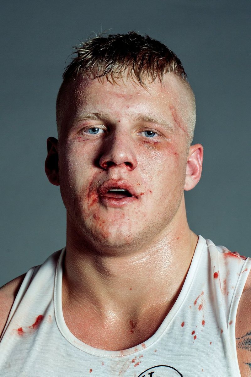 Gros-plan d'un boxeur couvert de sang et de contusions, quelques instants après avoir perdu un combat.