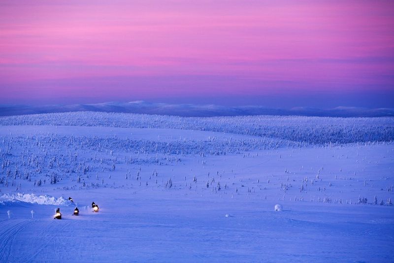 La neige aux reflets bleus fait ressortir un ciel rose et violet sur cette photo prise à midi en plein hiver finlandais.