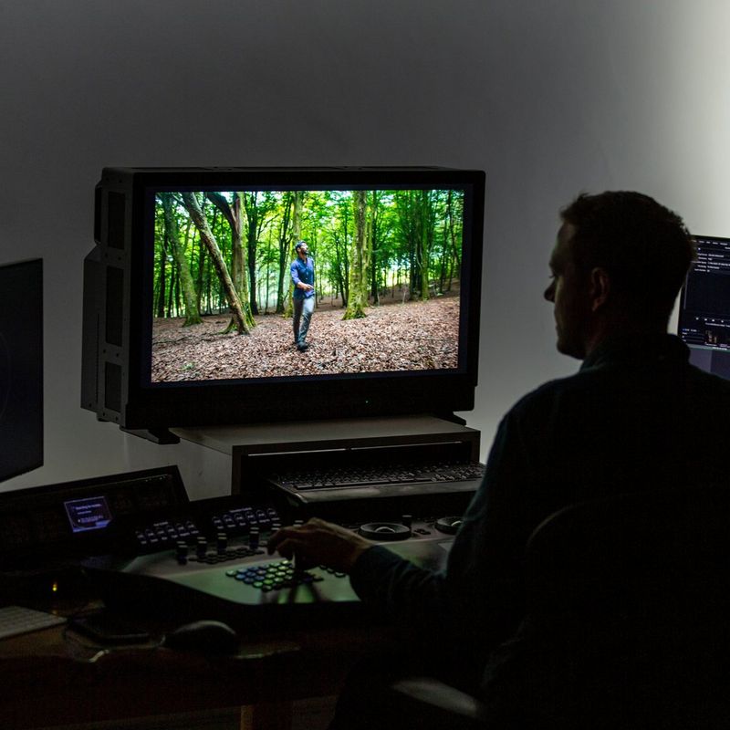 A computer in a video edit suite with two HD reference monitors.