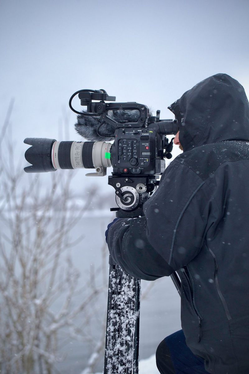 Roberto Palozzi films with an EOS C500 Mark II on a tripod looking out over a frozen landscape.