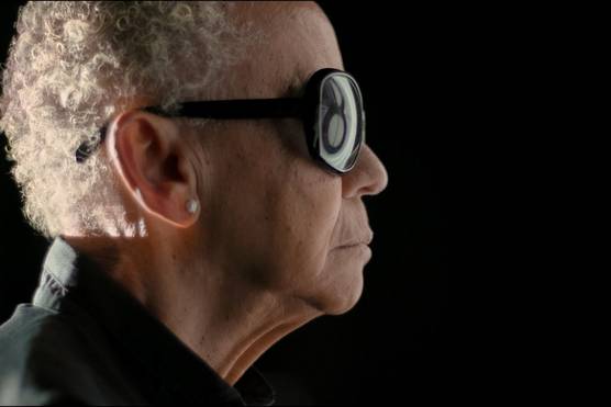 A still from Going to Mars: The Nikki Giovanni Project, filmed on a Canon EOS C300 Mark II, showing Nikki in side profile wearing sunglasses. 