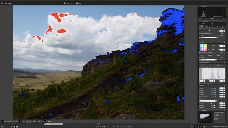 A landscape photo in DPP with a red overlay on highlights in the clouds and blue on clipped shadows in the dark foreground.