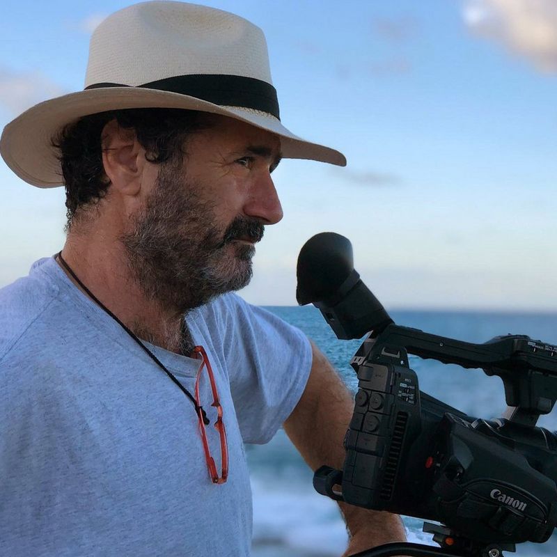 DoP Alfonso Parra looking out to sea with the Canon XF705 camcorder.
