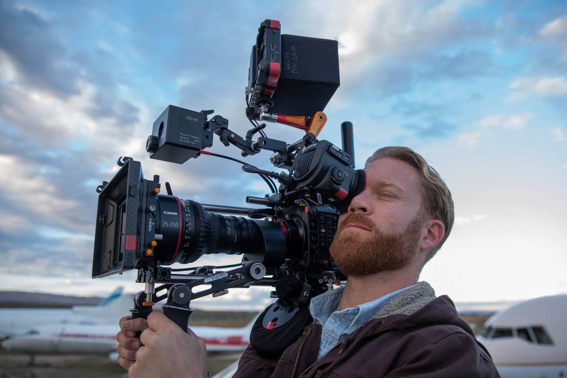 Cinematographer Steve Holleran holds a Canon EOS C300 Mark III on his shoulder.