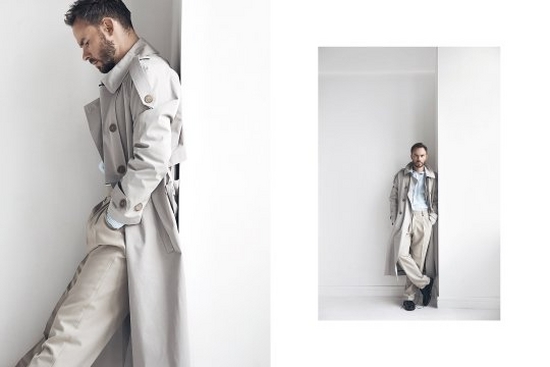 A male model wears a white coat and stands against a white wall in two shots by fashion photographer Jaroslav Monchak.