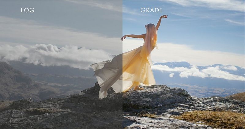 A ballet dancer in a flowing yellow dress and shawl poses atop a mountain overlooking a valley, with half the frame showing the Canon Log version, and the other, the graded one. 