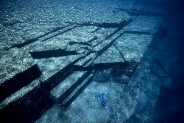 Freediver Guillaume Nry lies on the surface of an ancient underwater structure off the coast of Japan. 
