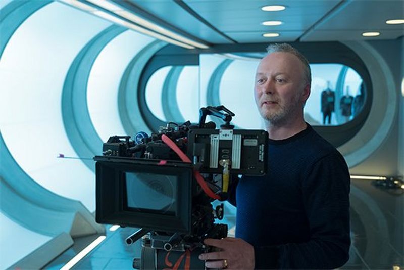 A macro shot showing the inside of a yellow poppy with dew droplets on the petals. 