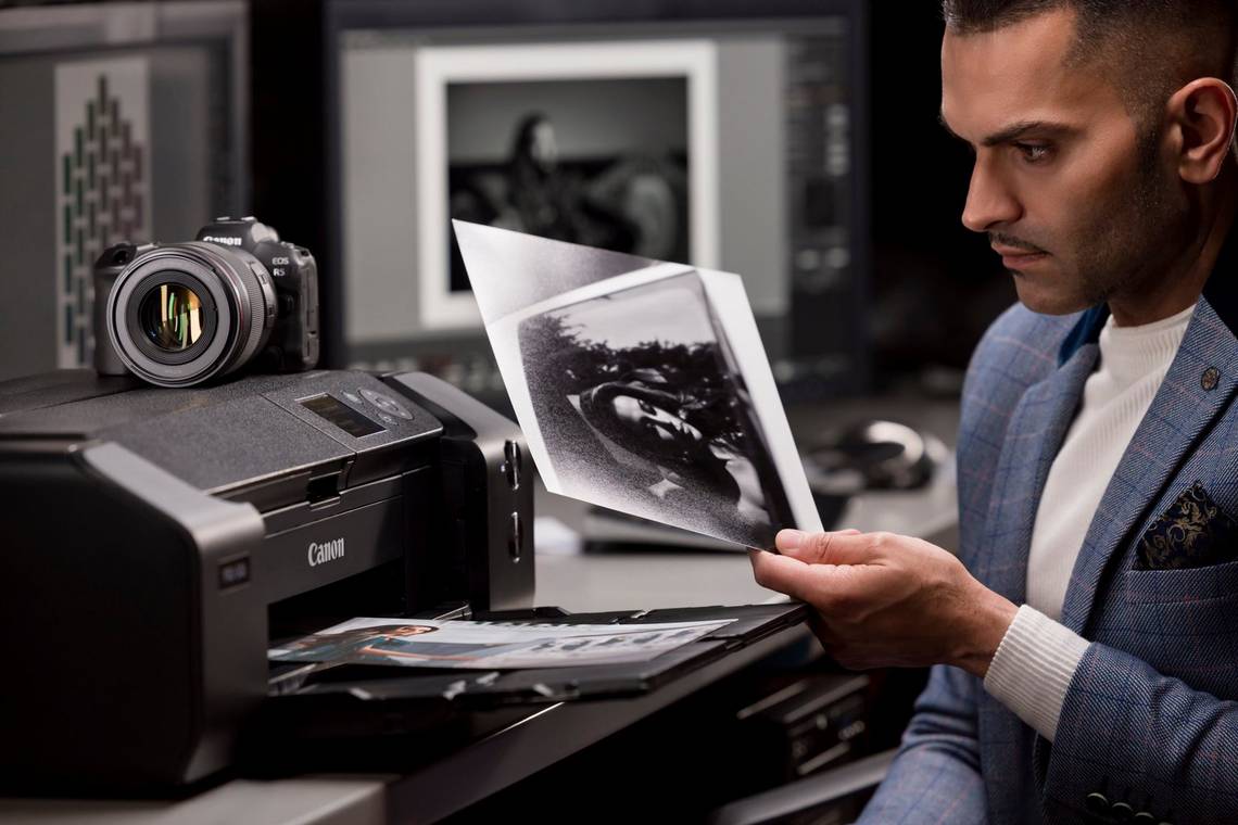 Wedding photographer Sanjay Jogia holds a black and white image printed on a Canon imagePROGRAF PRO-300.