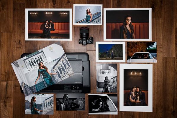A selection of prints arranged around a Canon imagePROGRAF PRO-300 printer. 
