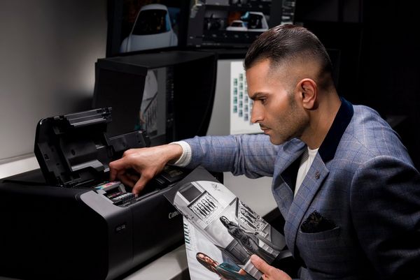 Wedding photographer Sanjay Jogia changes the ink cartridge in a Canon imagePROGRAF PRO-300 printer.