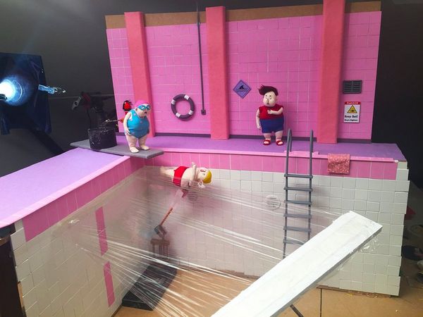 Characters being photographed in a swimming pool scene for No, I Don't Want to Dance!